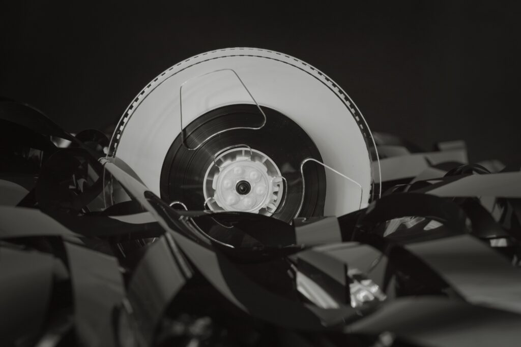 Close-up of a vintage cassette tape against a black background, showcasing retro technology.
